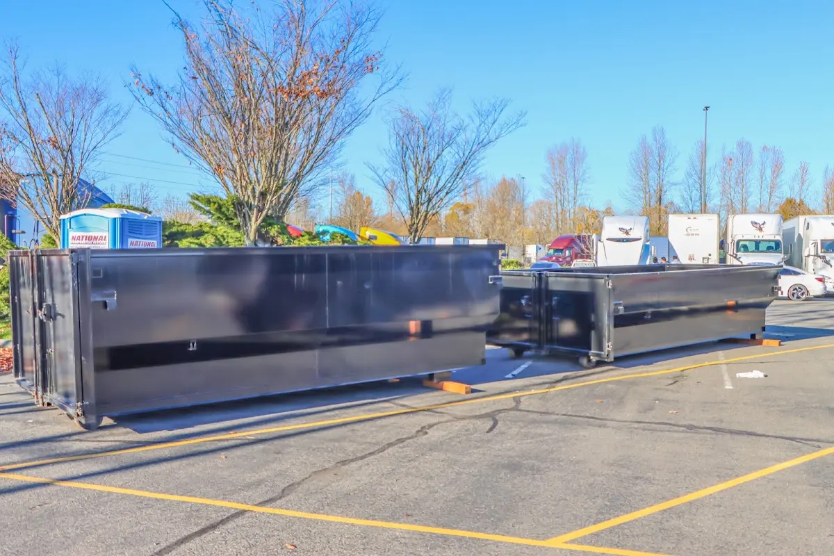 Professional dumpster rental service with roll-off container on residential driveway in South Jordan